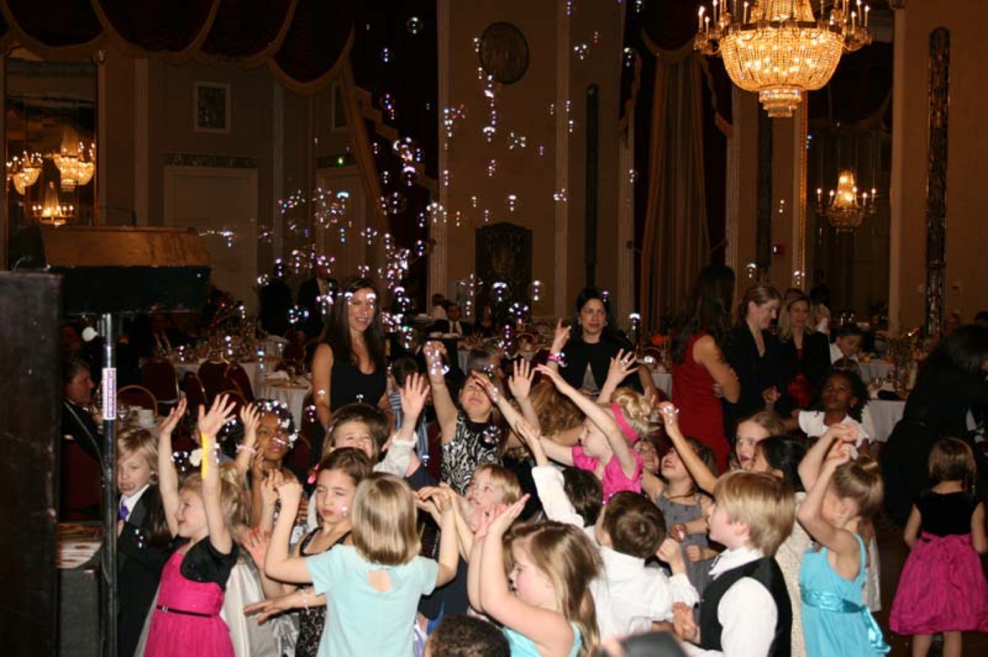 Guests dancing as bubbles fill the room