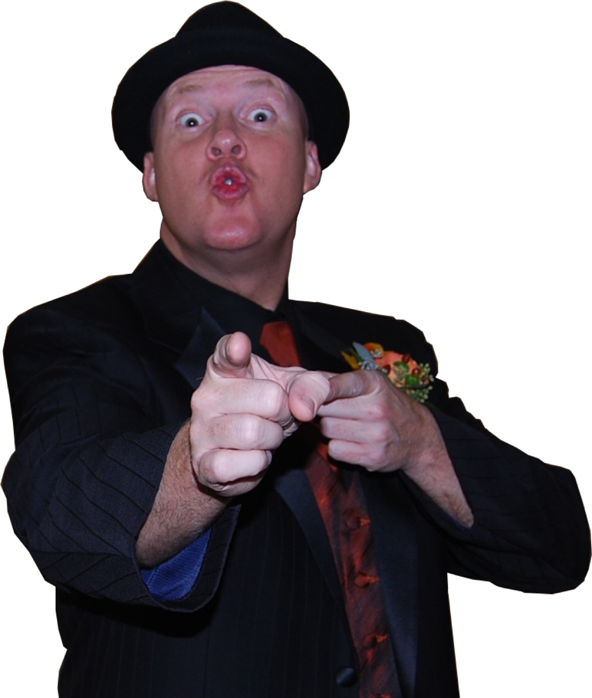 Kenny Casanova pointing at the camera in a suit and hat