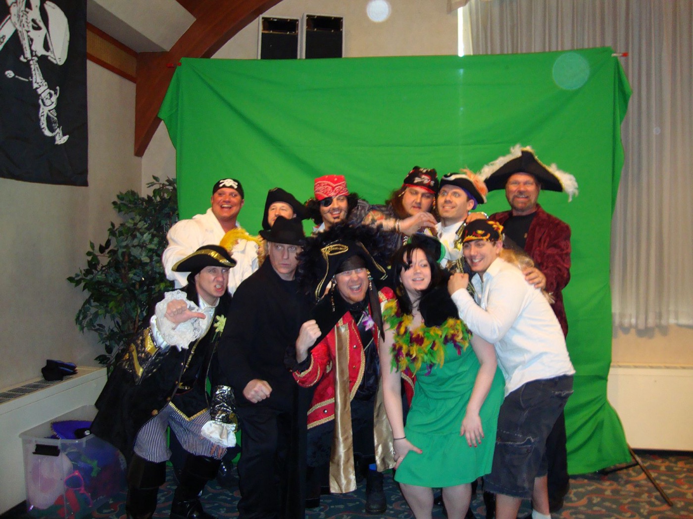 Guests in props posing at a green-screen photo booth