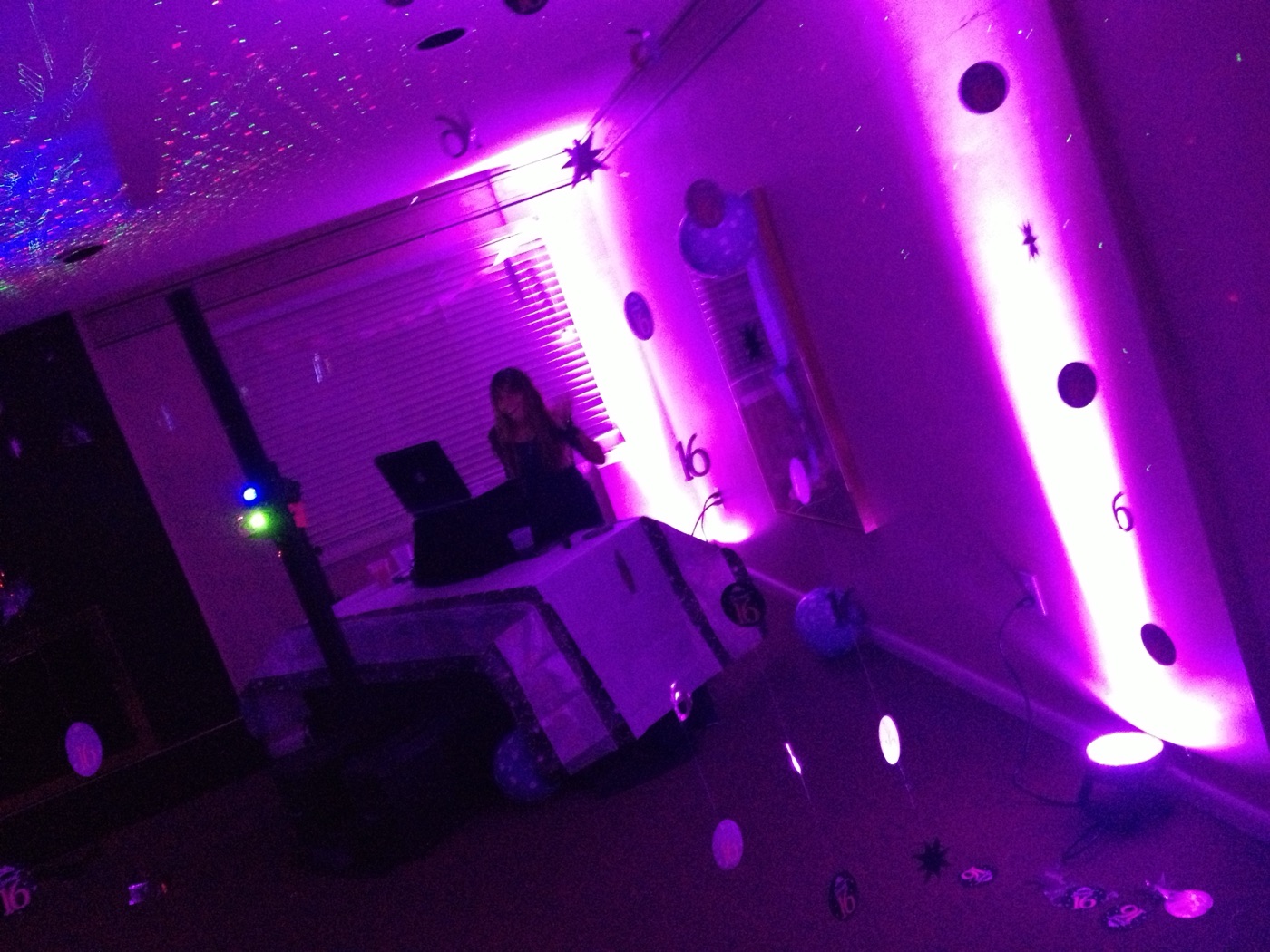 A sweet 16 party glowing in pink light
